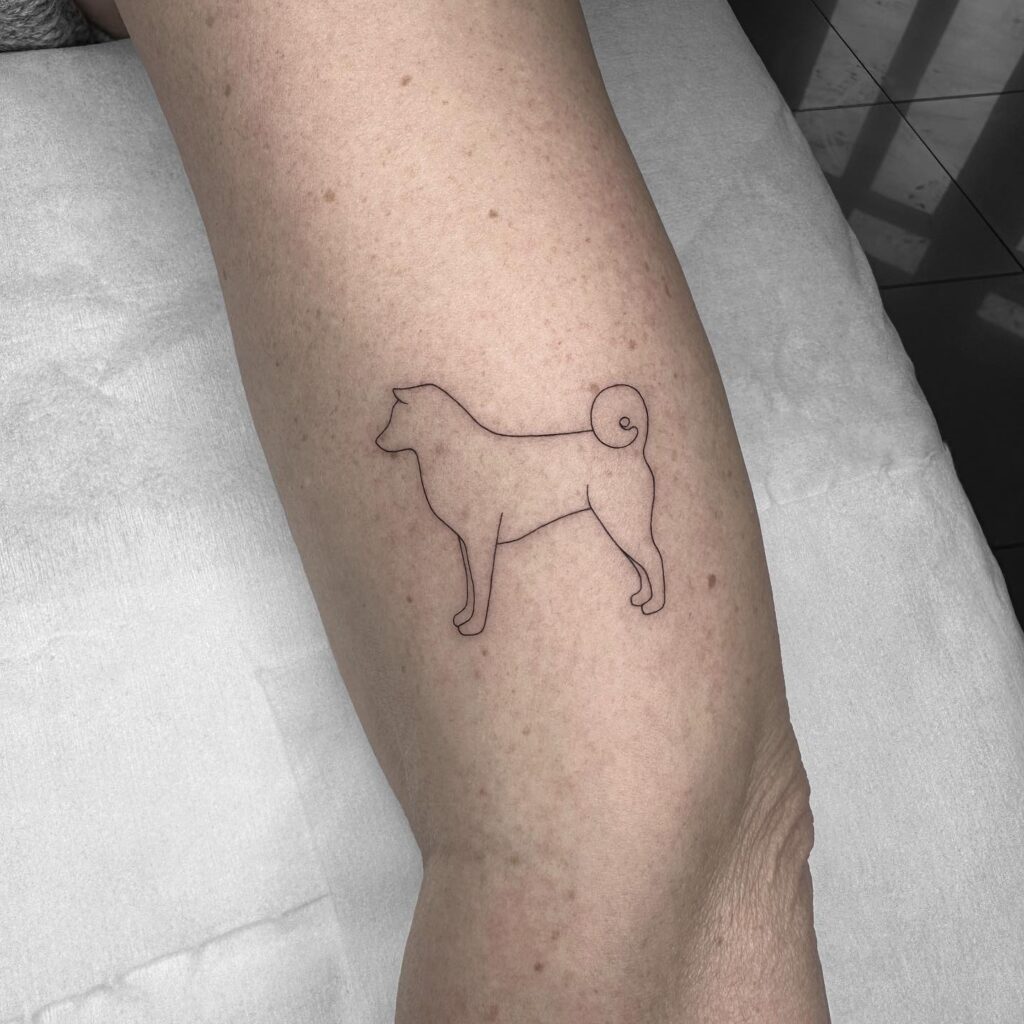 Dog Shape Side View Outline Tattoo on the Upper Arm: Paw-fect Profile