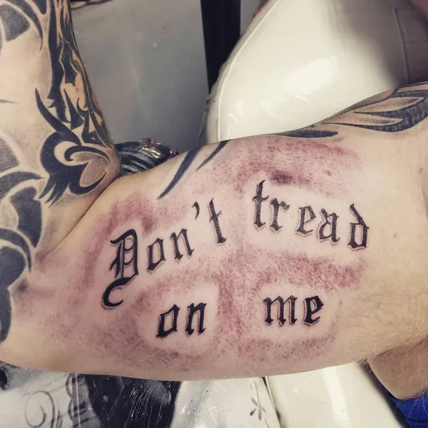 Don't tread on me tattoo on bicep