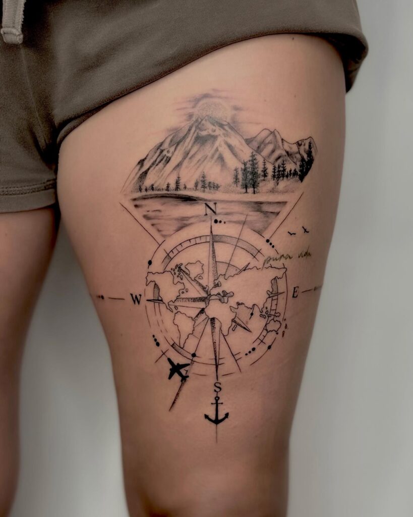 Dotwork Compass Tattoo Inside a World Map on the Thigh, Featuring Mountains, Sunrise, and a River: Worldly Direction