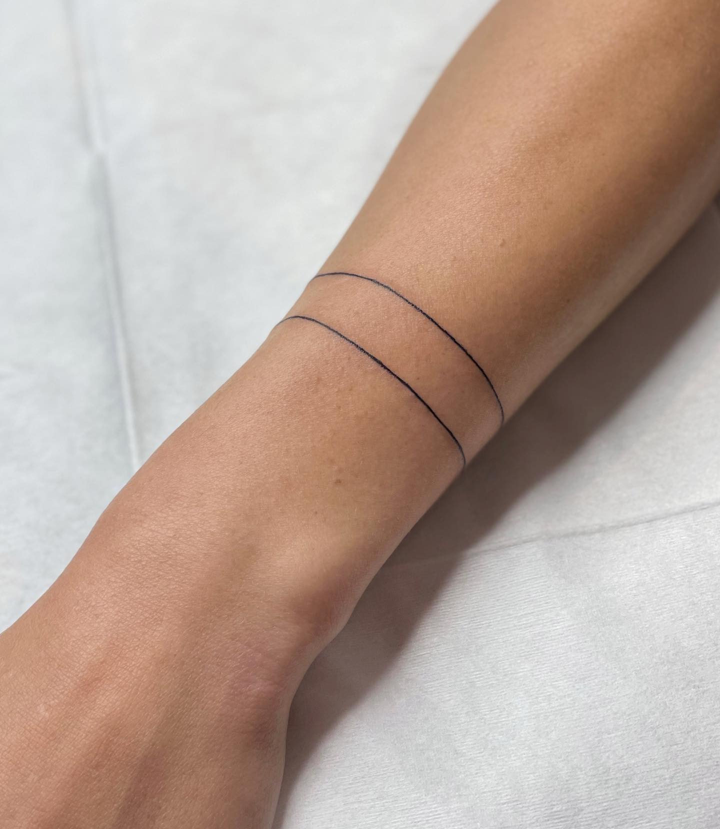 Double Line Wrist Tattoo Minimalist Bracelet-Inspired Design Symbolizing Strength