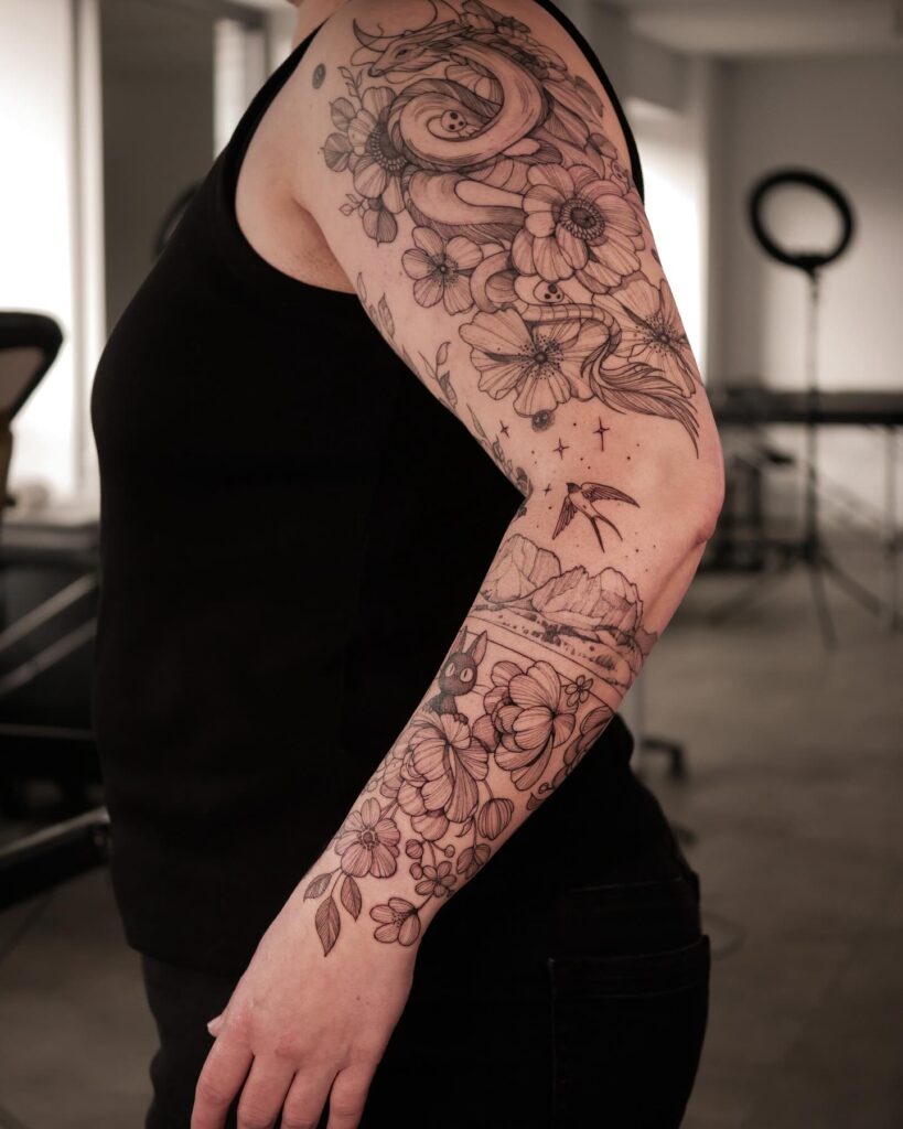 Dragon and flower tattoo sleeve with yin-yang symbols and a whimsical mountain scene