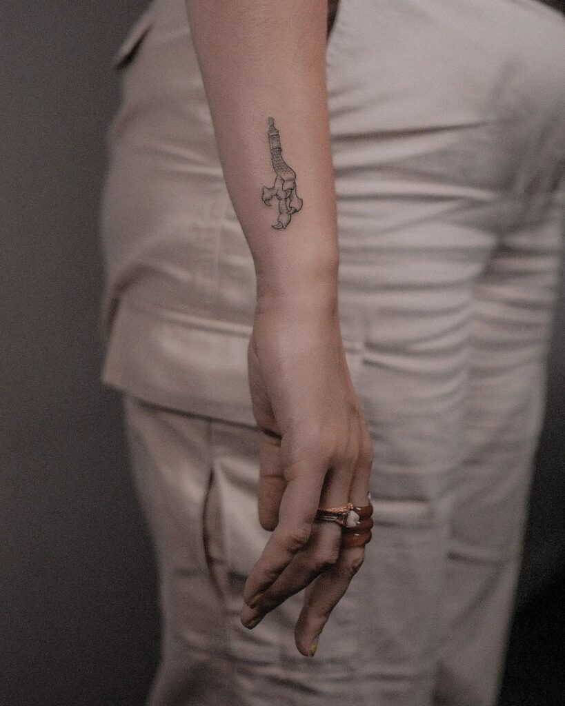 Dragon claw charm unveiling dark grey side wrist ink for a mysterious vibe