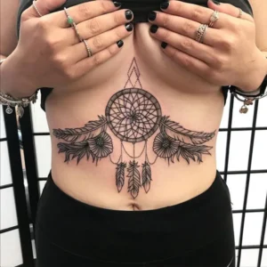 Dream catcher tattoo under breast 1