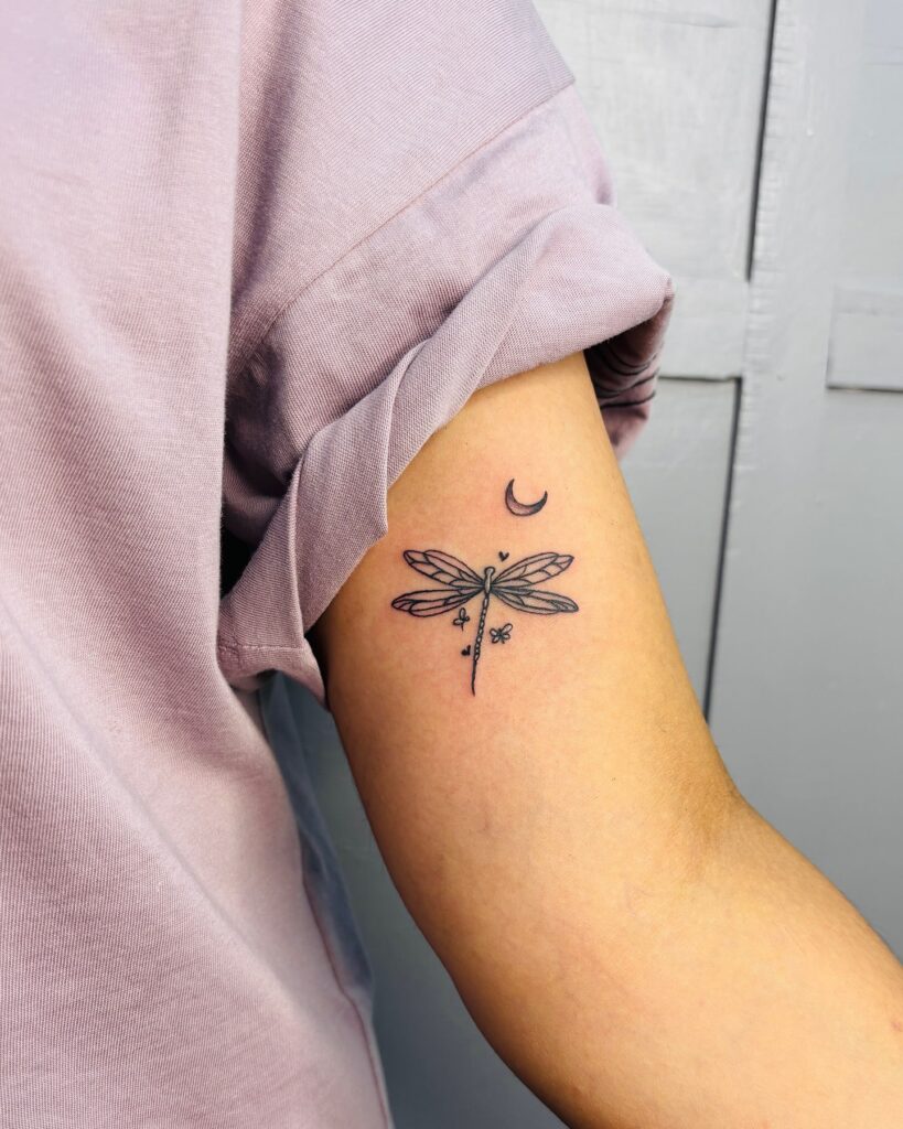 Dreamy Inner Arm Dragonfly Tattoo with a Crescent Moon and Star Accents