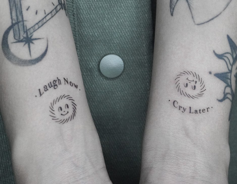 Dual expression laugh now on one wrist cry later on the other 