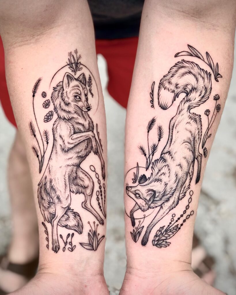 Dual playing fox and wolf forearm tattoo a harmonious wildlife scene