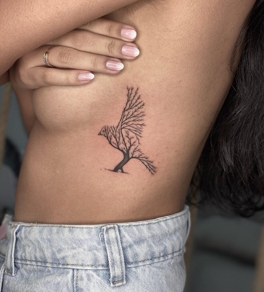 Eagle shaped tree creative tattoo on the side rib for female majestic nature inspired ink