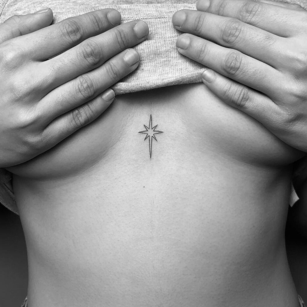 Eight-point star sternum tattoo representing hope, guidance, and enlightenment