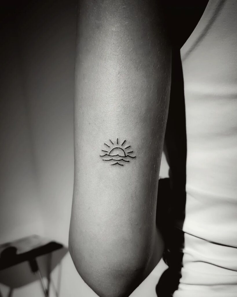 Elbow wave and sun tattoo sleeve beauty