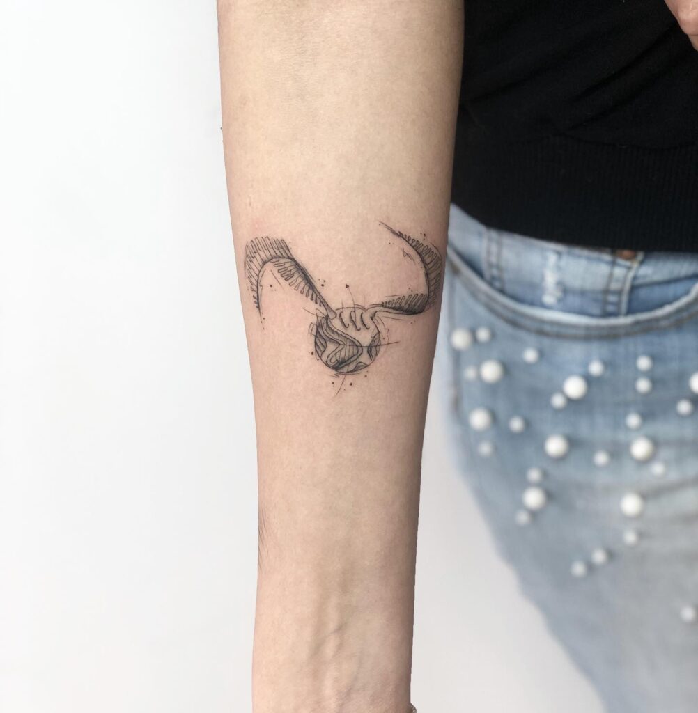 Elegant fine line golden snitch tattoo minimalist magic