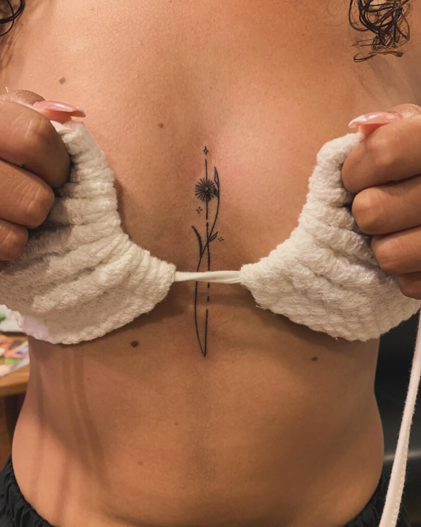 Elegant floral sternum tattoo with geometric and celestial elements