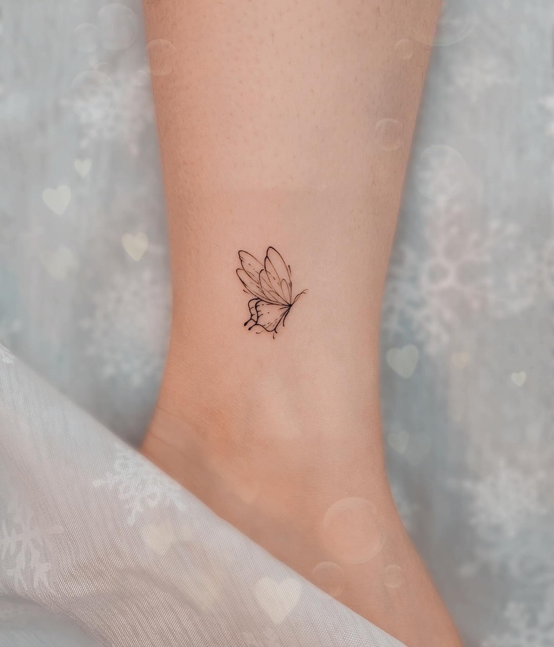 Elegant inner ankle butterfly tattoo symbolizing freedom and femininity