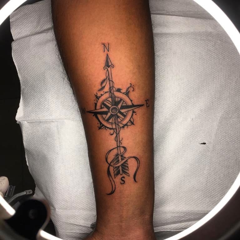 Elegant navigation compass & arrow forearm tattoo
