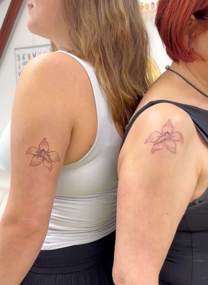 Elegant Orchid Flower Mother Daughter Tattoos Representing Strength and Bond
