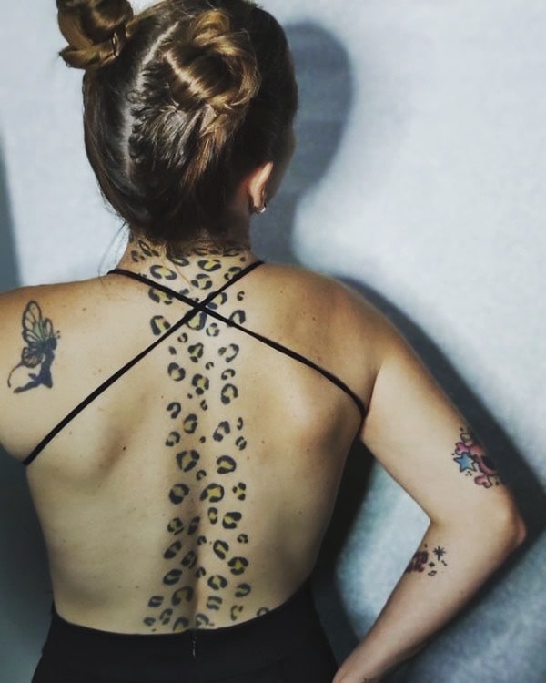Elegant spine leopard print tattoo ideas for females