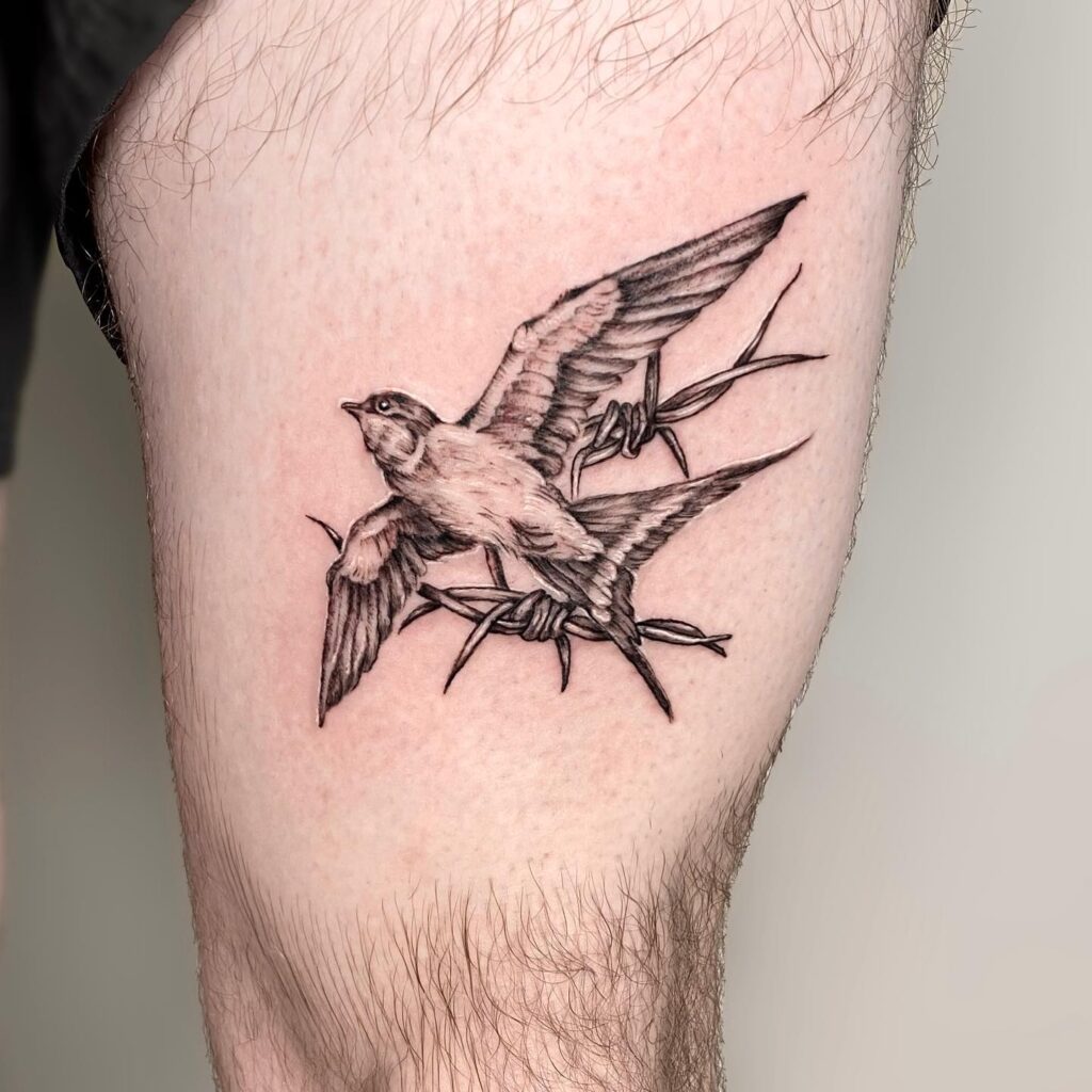 Embracing above the knee elegance the realistic swallow tattoo