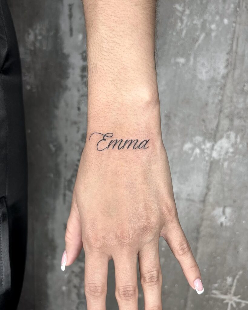 Emma calligraphy text tattoo on the outer wrist personalized elegance