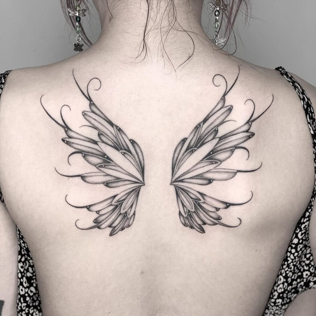 Enchanting & whimsical fairy wings back tattoo