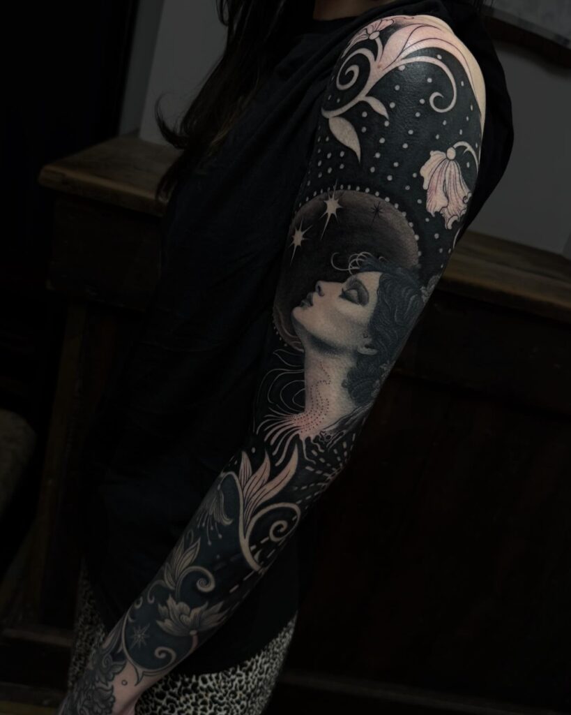 Ethereal Black and Grey Full-Sleeve Tattoo with Celestial Accents