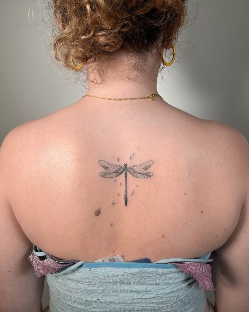 Ethereal Upper Back Dragonfly Tattoo with Delicate Star Accents
