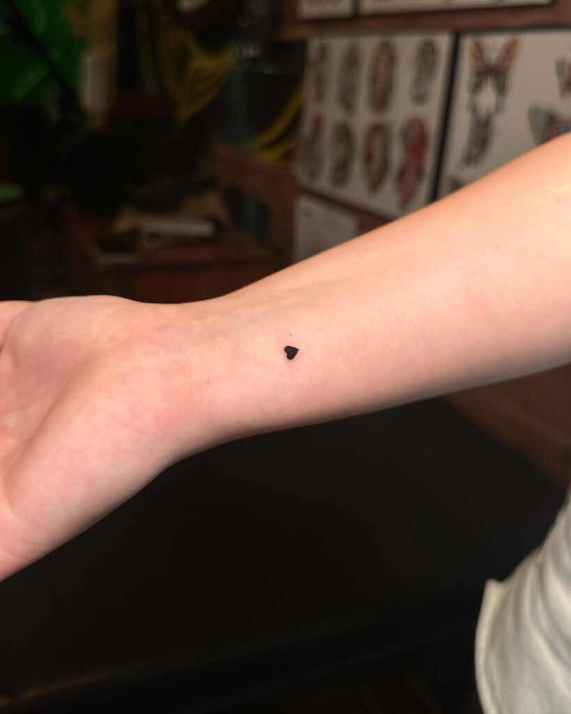 Exploring the Minimalist Charm of a Tiny Heart Tattoo on the Inner Wrist: Tiny Heartbeat