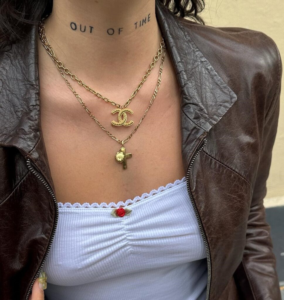 Expressive artistry out of time word tattoo on the front neck