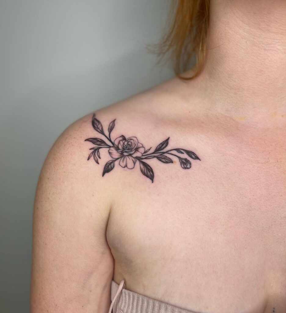 Extra delicate fine line rose on the collarbone: botanical elegance