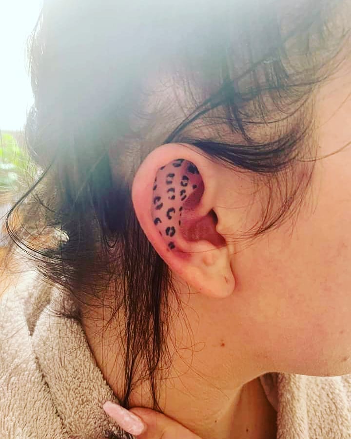 Exuding Elegance: Leopard Print Tattoo on Ear