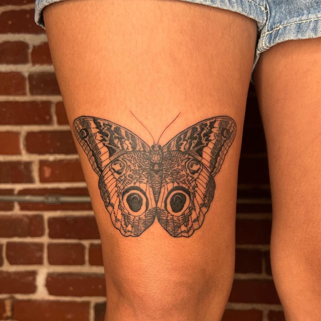 Eyes of wisdom butterfly and owl tattoo on thigh
