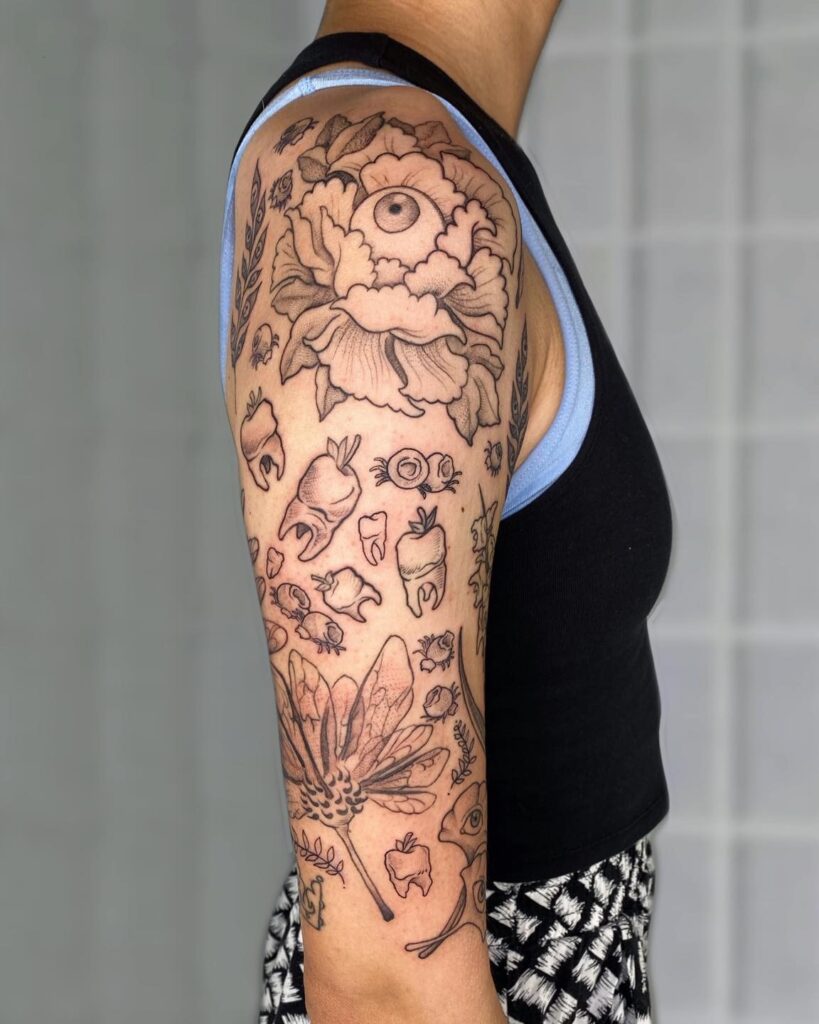 Eyes, teeth, and crawlers creepy half sleeve tattoo for the bold