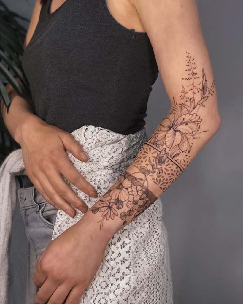 Fabulous florals lower half sleeve tattoo with a feminine touch