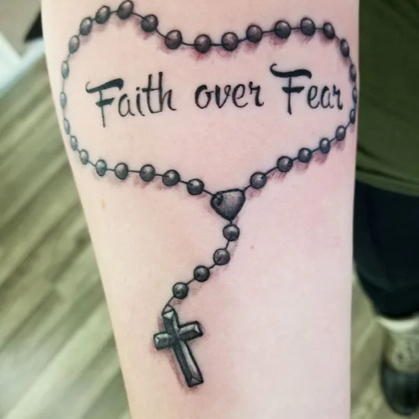 Faith over fear tattoo with cross