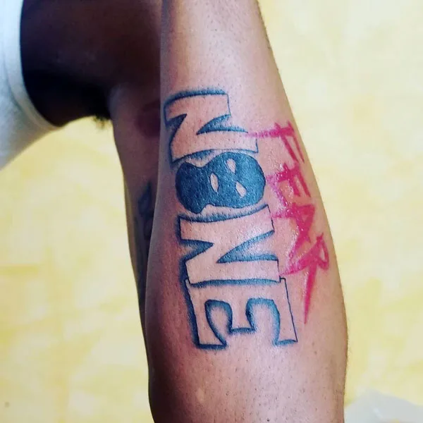 Fear none tattoo forearm