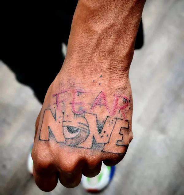 Fear none tattoo on hand