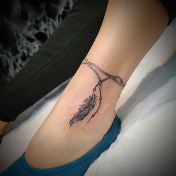 Feather ankle bracelet tattoo