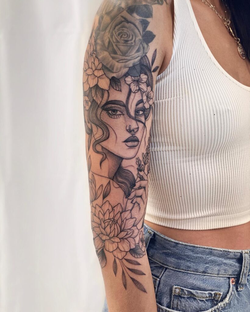 Feminine portrait adorned with roses a half sleeve tattoo masterpiece