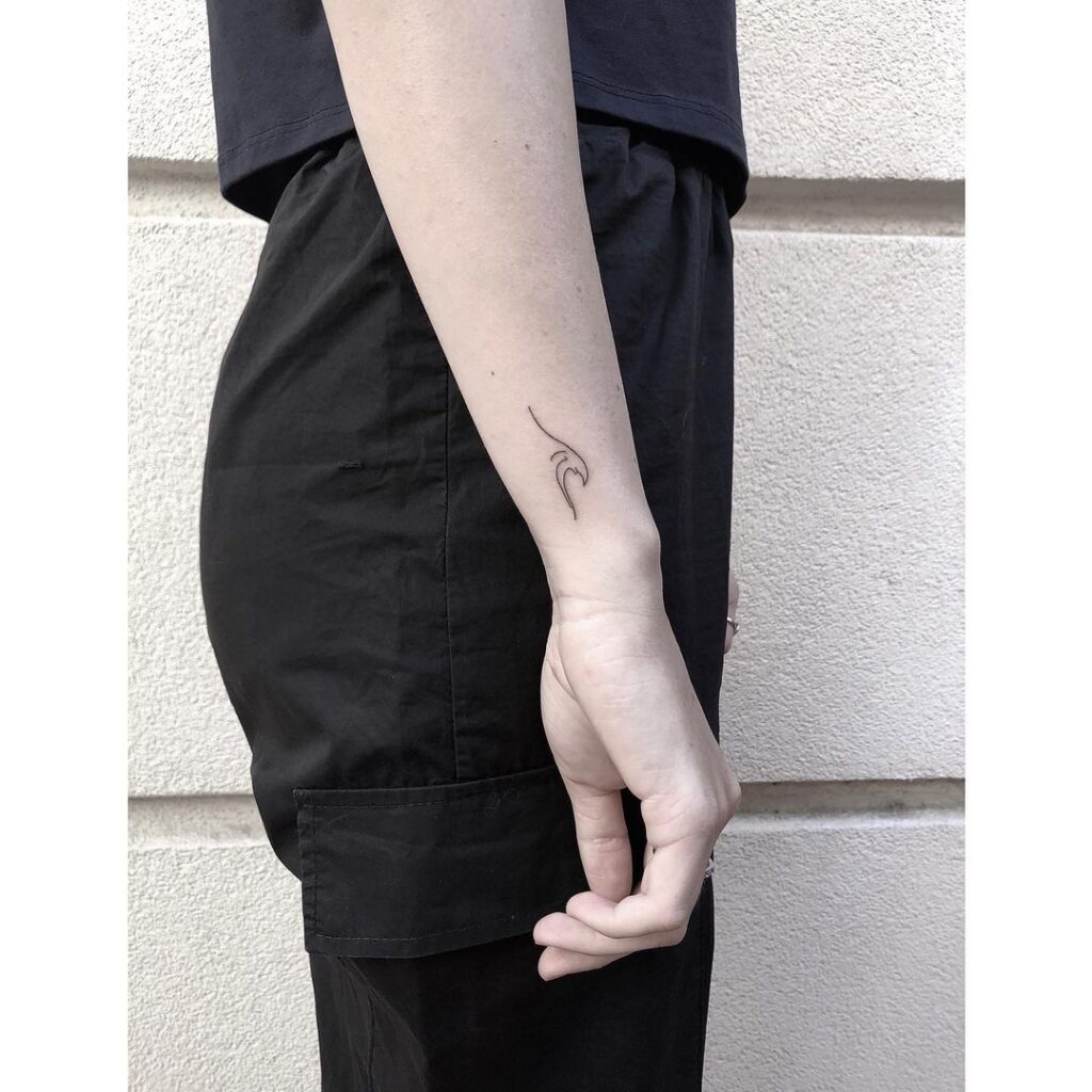 Feminine sea wave outline side wrist tattoo for women