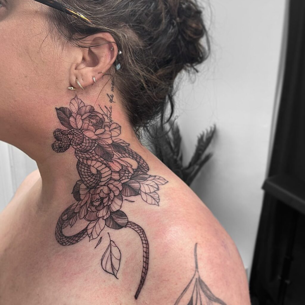 Feminine side neck tattoos snakes and blooming flowers