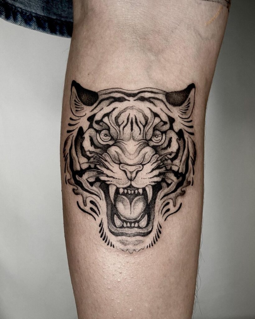 Fierce and bold roaring tiger calf tattoo design ideas 
