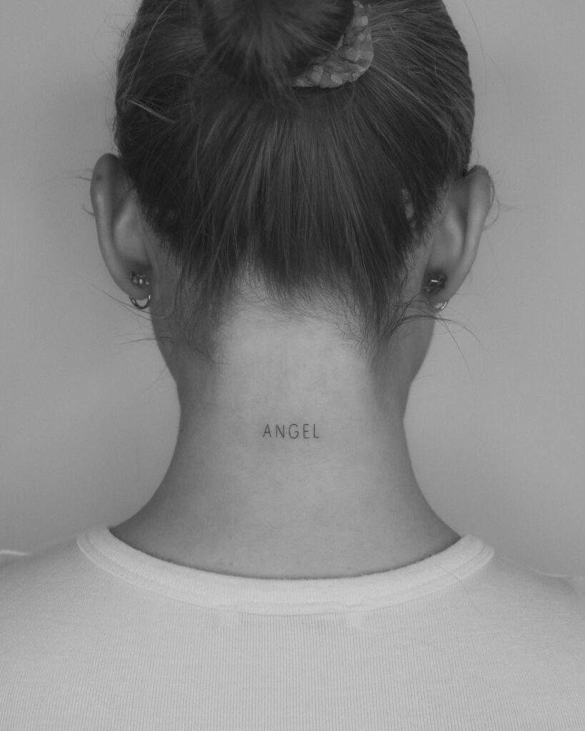 Fine-line angel word tattoo on the back of the neck for spiritual meaning
