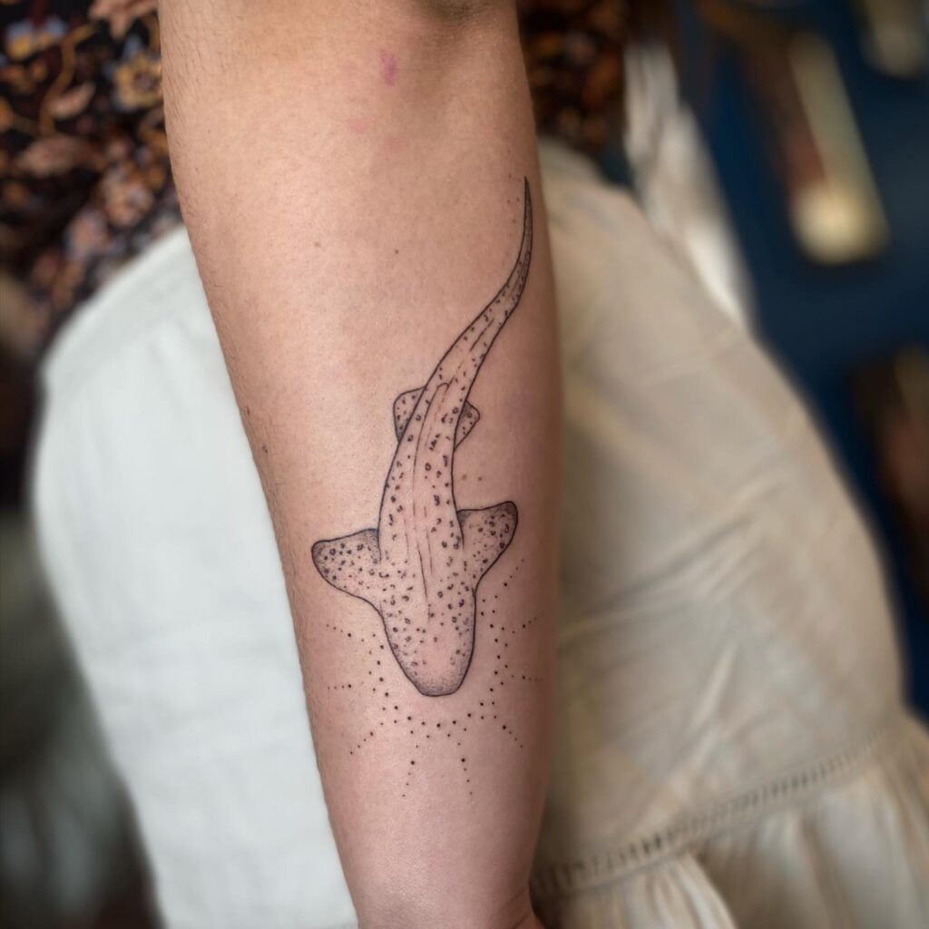 Fine line bamboo shark tattoo with dotwork shading and circular design