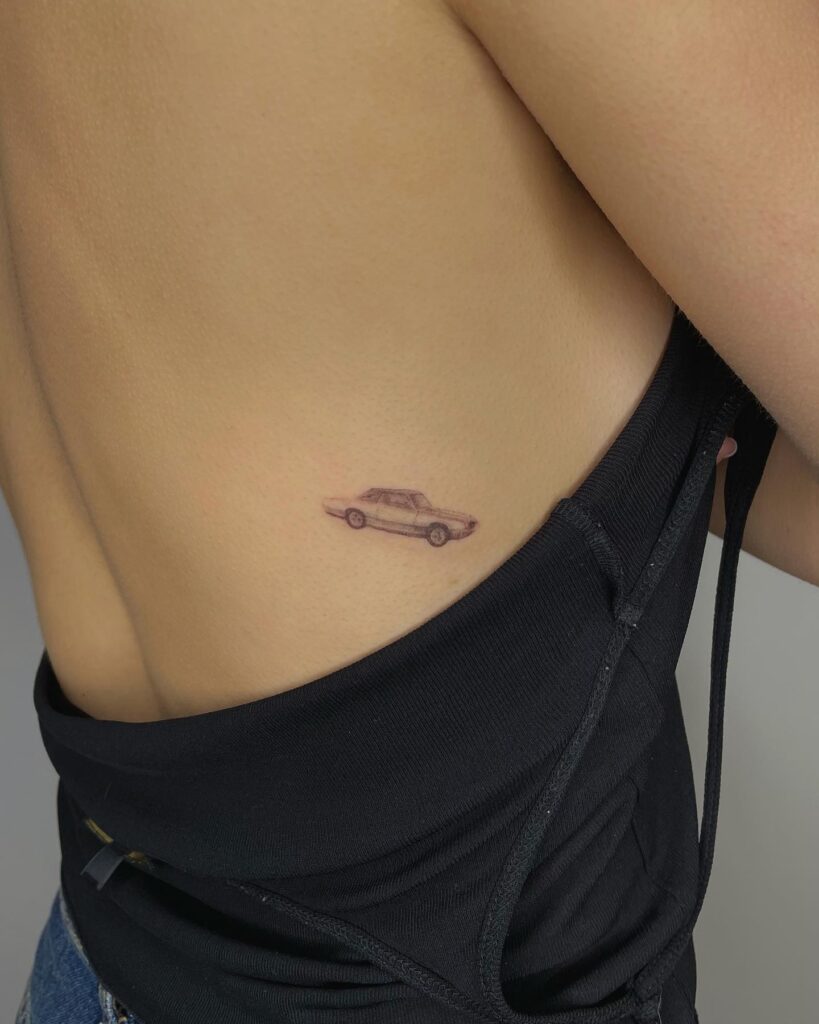 Fine-Line Black and Gray Vintage Car Tattoo on Side Ribcage with 3D Shading