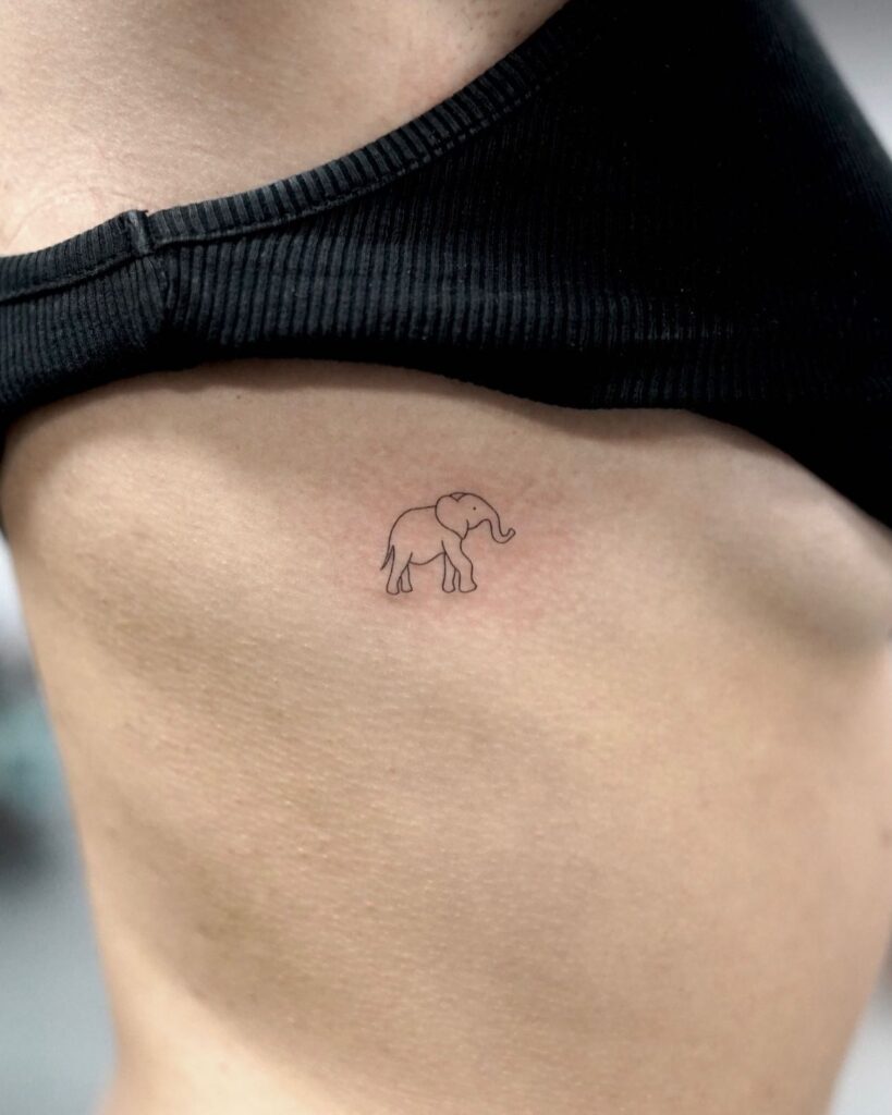 Fine line elephant tattoo on the right side ribcage, a very thin and outline rendering of a side view subtle ribcage elegance