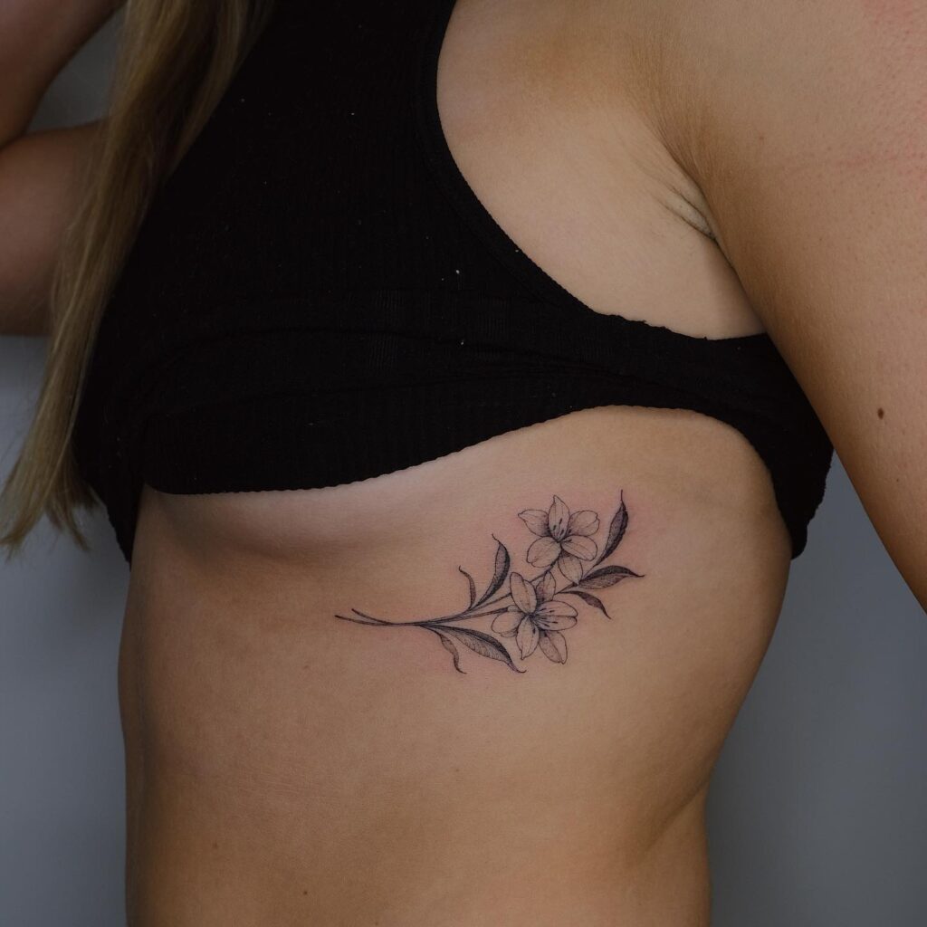 Fine line lily flowers tattoo on the rib: lily symphony