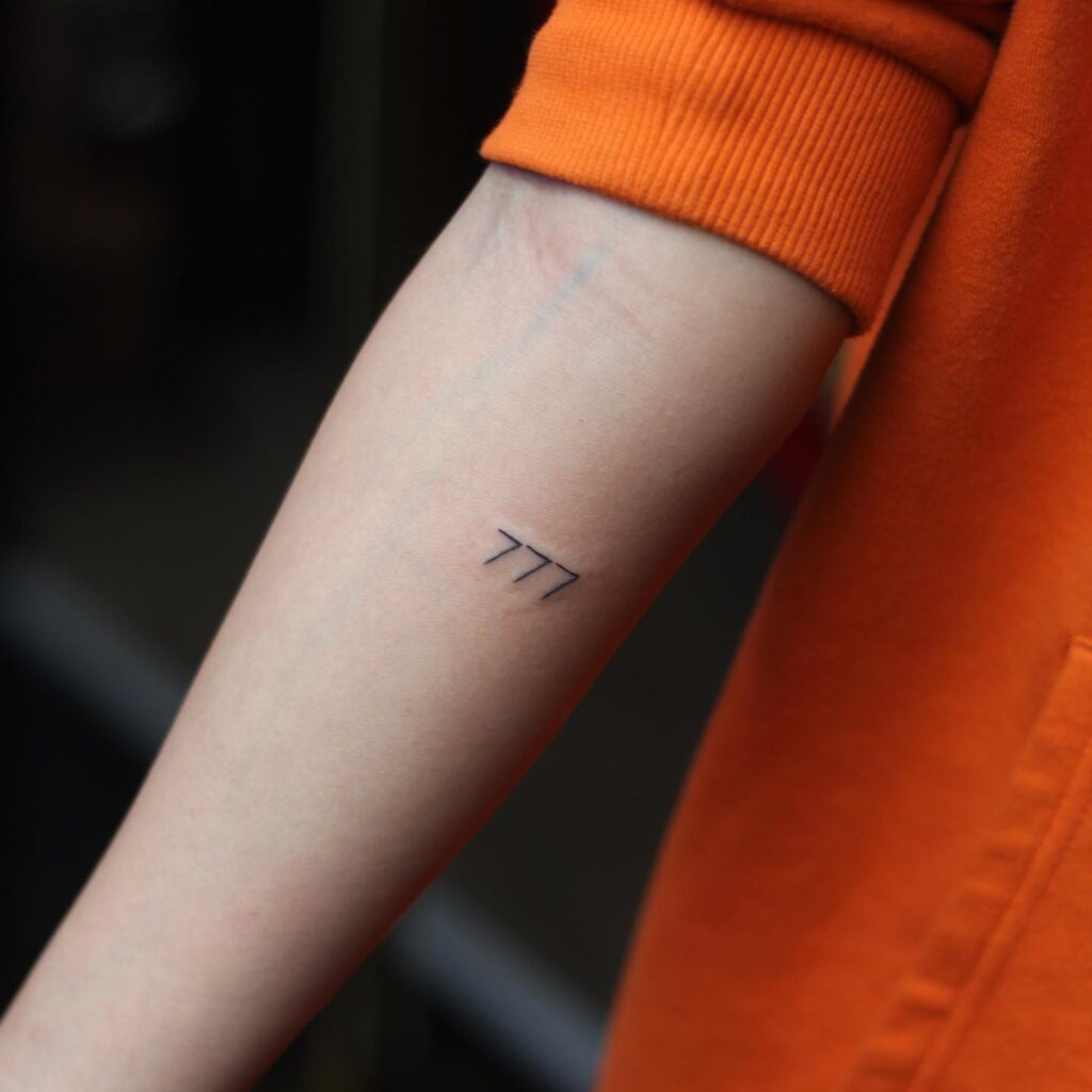 Fineline 777 Tattoo Below the Elbow for an Understated Look: Subtle Charm 