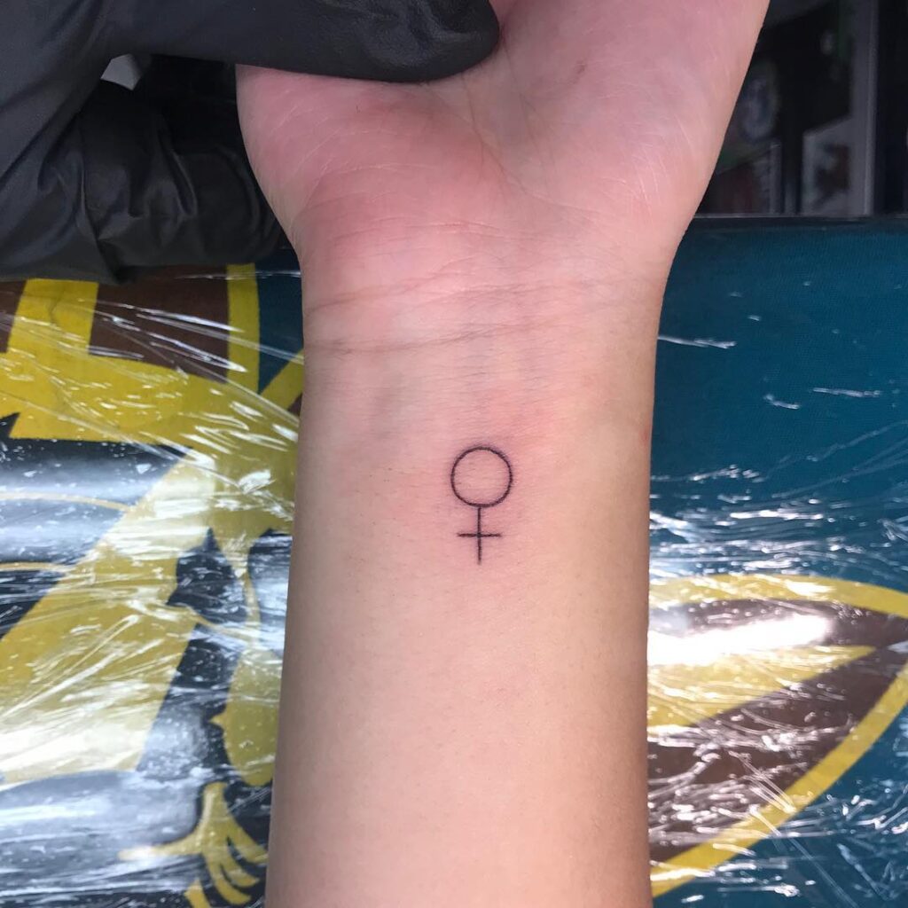 Fineline Venus Symbol Tattoo on the Inner Wrist Merging Femininity and Cosmic Allure Celestial Elegance
