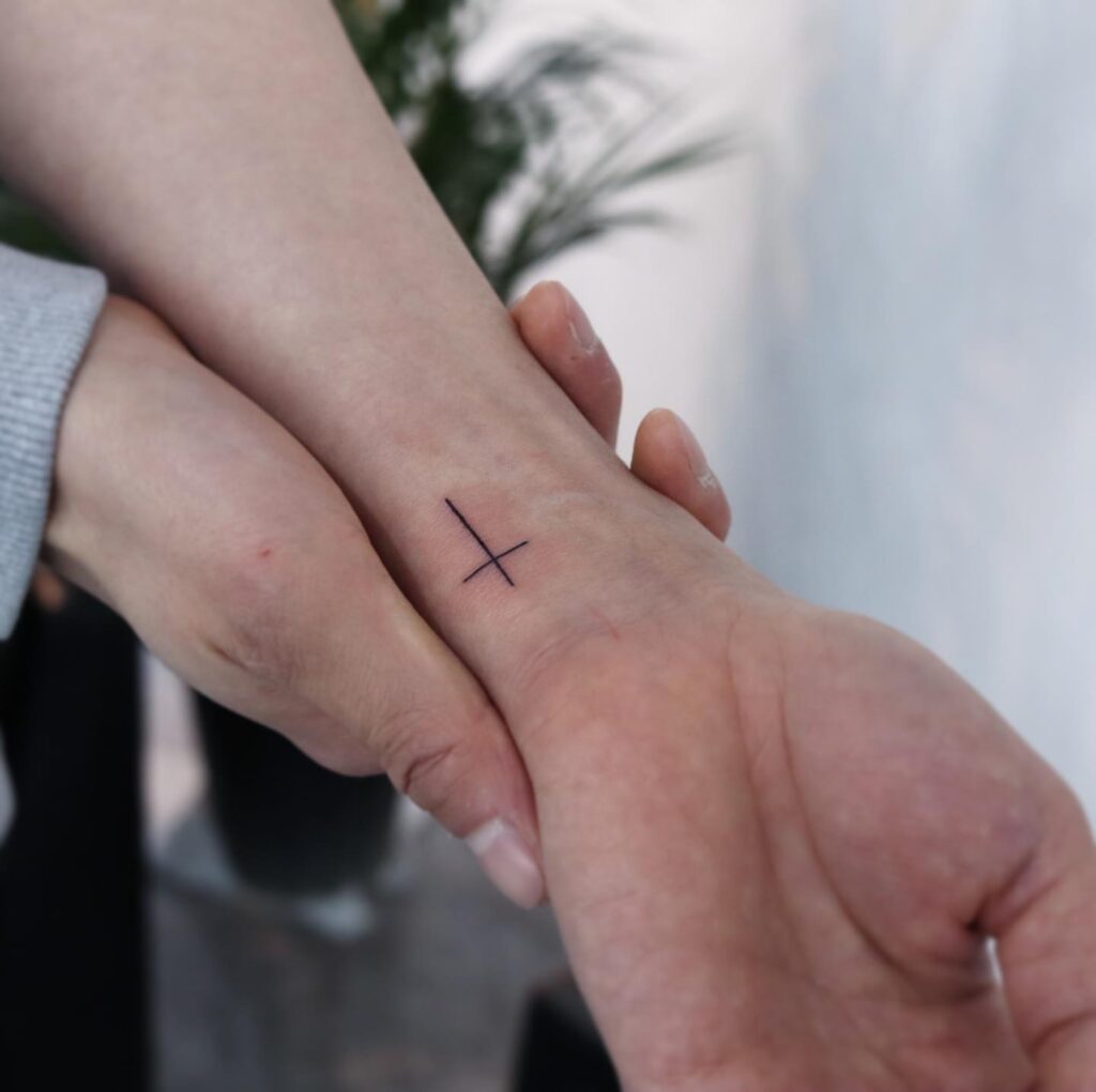 Fineline cute simple cross tattoo designs wrist (inner) girl