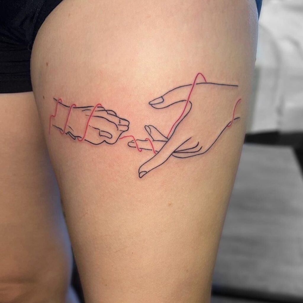 Fineline Dog Paw and Human Hand Tattoo on the Thigh with Red Accents: Thigh Tale