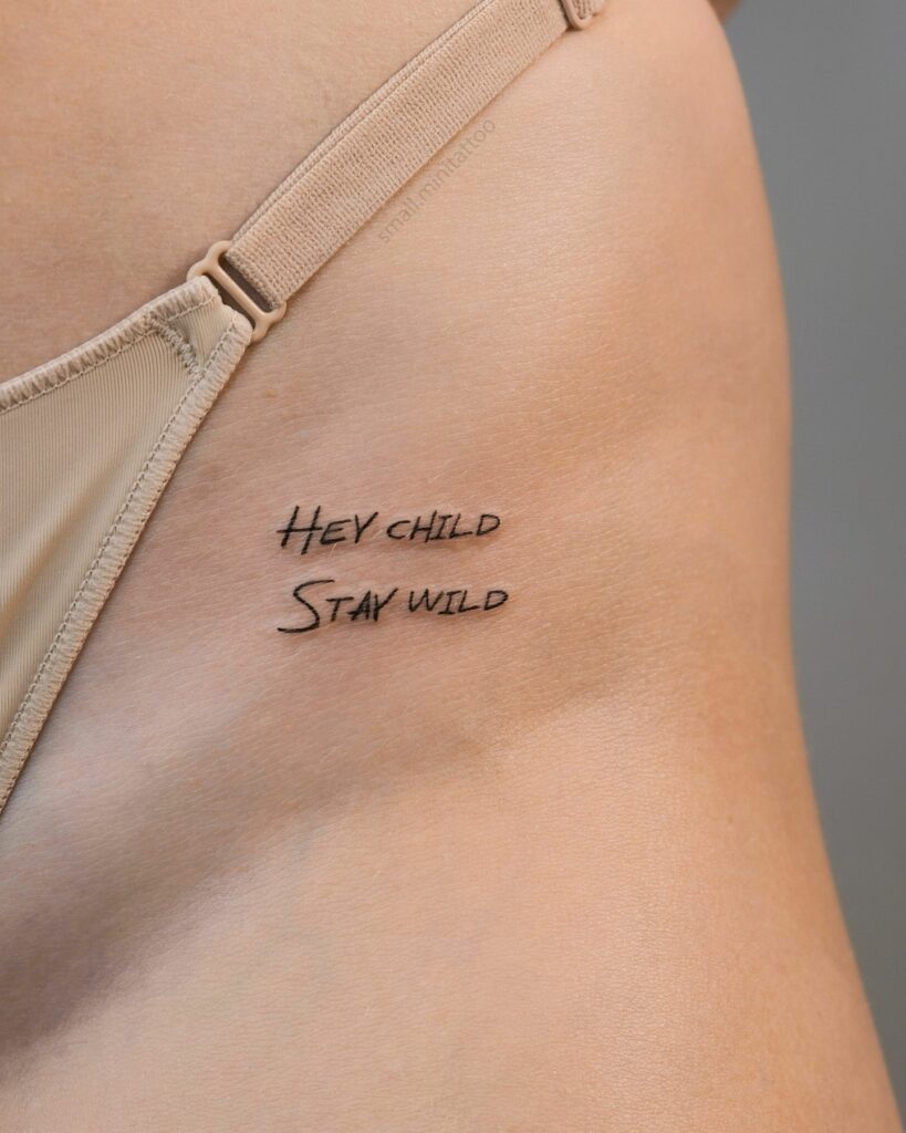 Fineline 'Hey Child Stay Wild' Tattoo on the Hip for Female, a Call to Freedom: Wild Child Anthem
