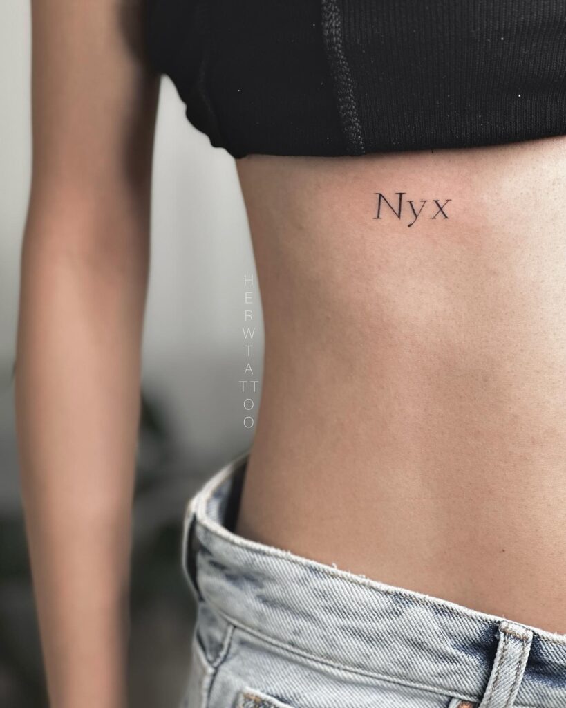 Fineline 'nyx' word text tattoo on the rib, a graceful and mysterious choice goddess tribute